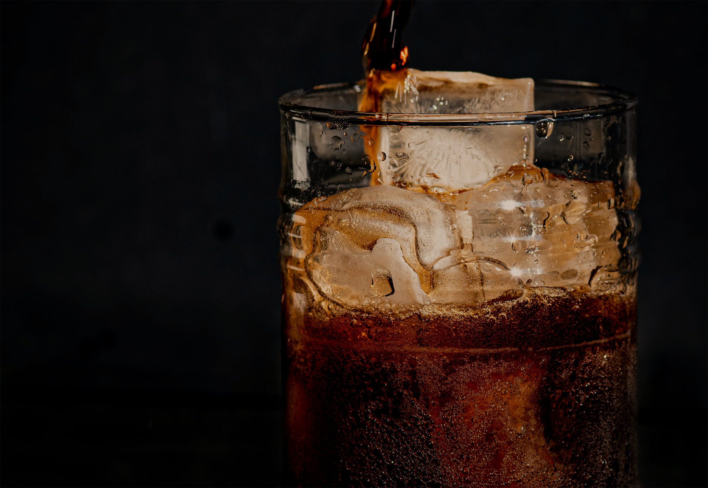 Glass of iced coffee with a dark background
